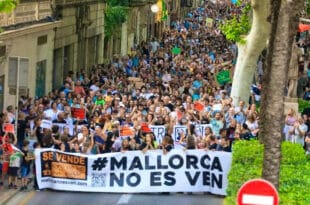 Residents of a Spanish town demonstrate against excesses of tourism